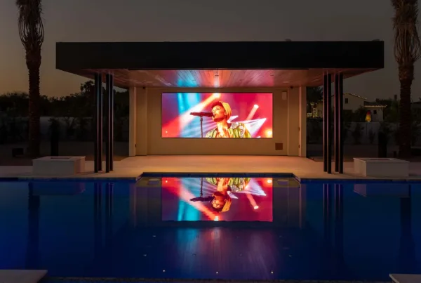 Large display in a covered poolside entertainment pavilion at dusk