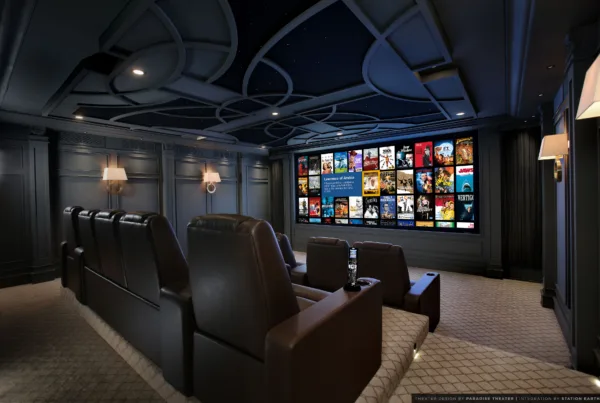 Private cinema with leather seating and a large screen showing the Kaleidescape movie library