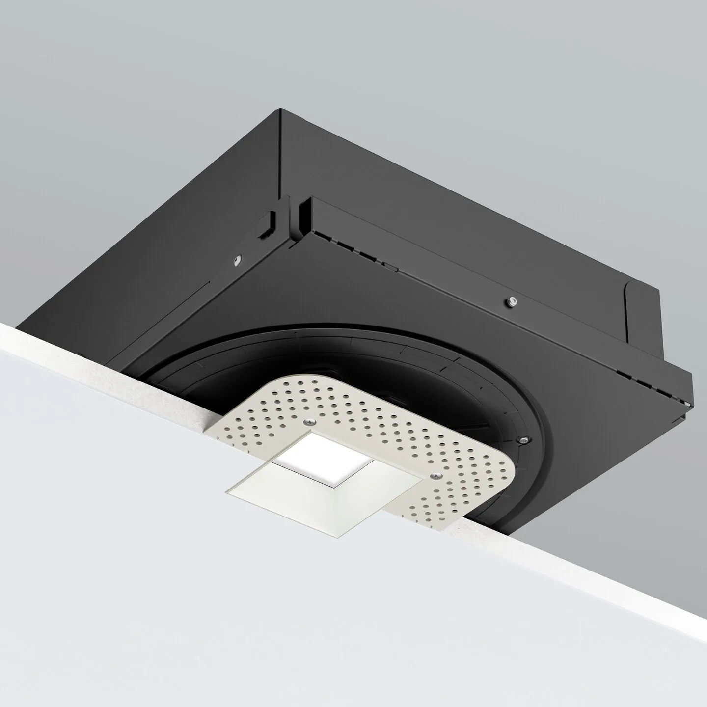 Black square ceiling-mounted light fixture with a round recessed element and a perforated metal plate hanging beneath the LED panel.