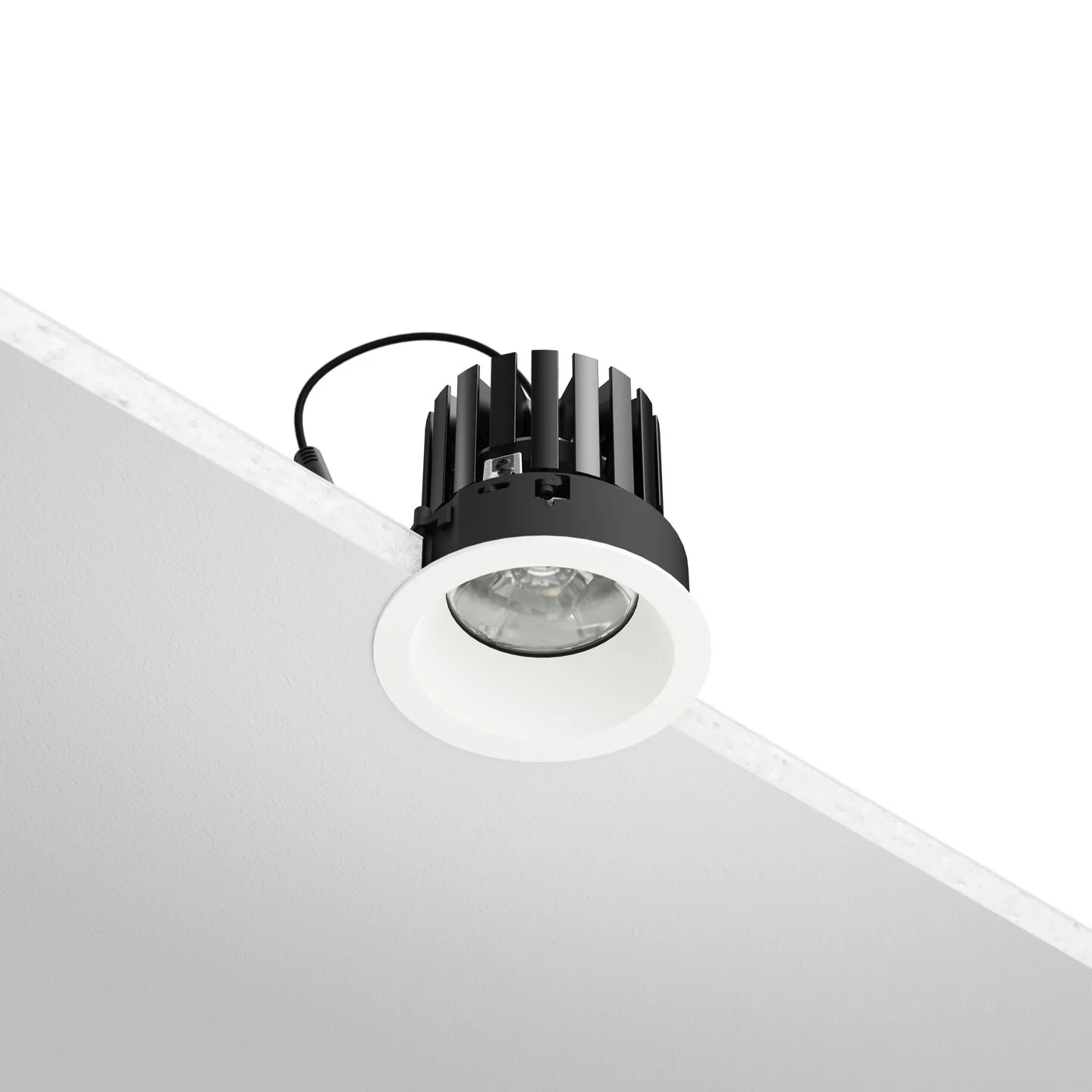 Black recessed LED downlight with white trim installed on a ceiling edge, showing a finned heatsink and power cord.