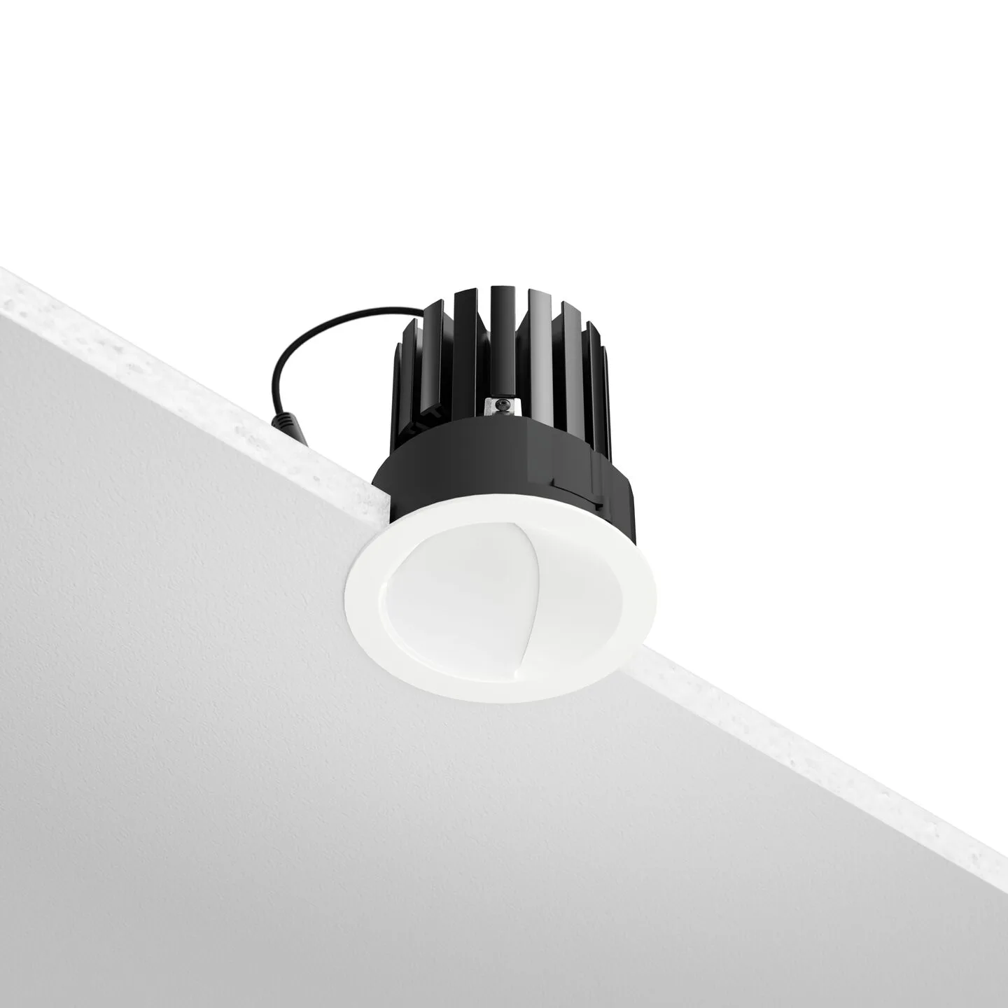 Ceiling-mounted recessed LED downlight with a black finned heat sink, set into a white angled ceiling surface.