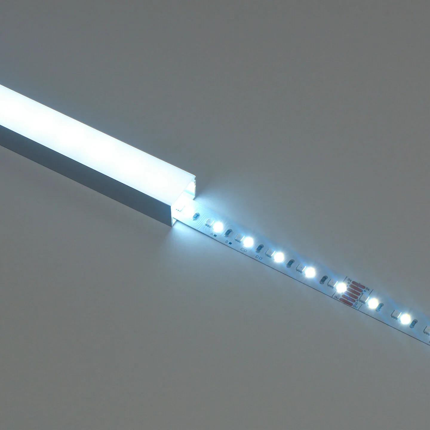 Flexible LED strip light with bright white LEDs aligned along a narrow aluminum channel at a diagonal angle