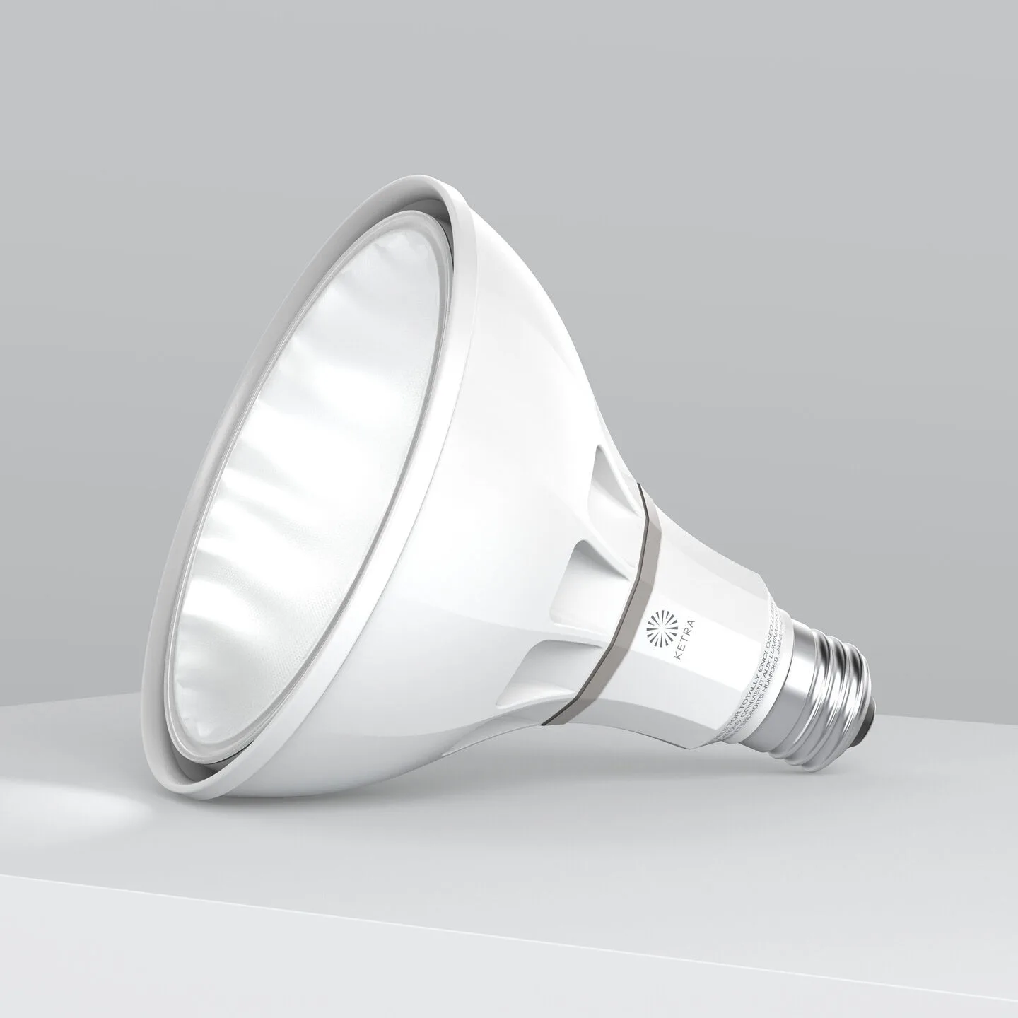 White, modern LED spotlight bulb lying on its side against a gray gradient background, showing its large reflective interior surface and screw base.