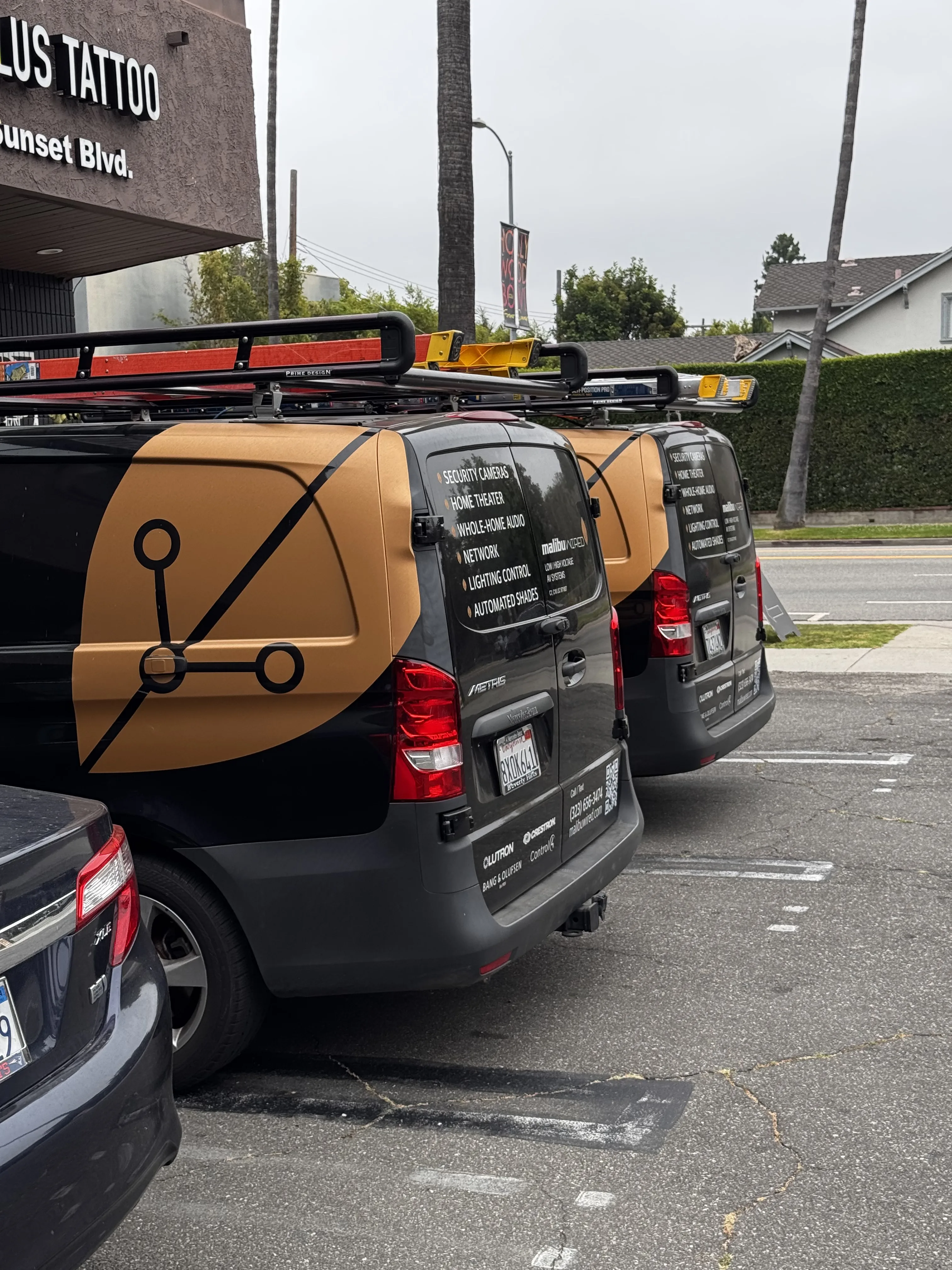 Malibu Wired service vans with roof ladder racks parked in a lot.