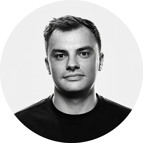 Head-and-shoulders portrait of a man with short dark hair wearing a black shirt, looking at the camera.